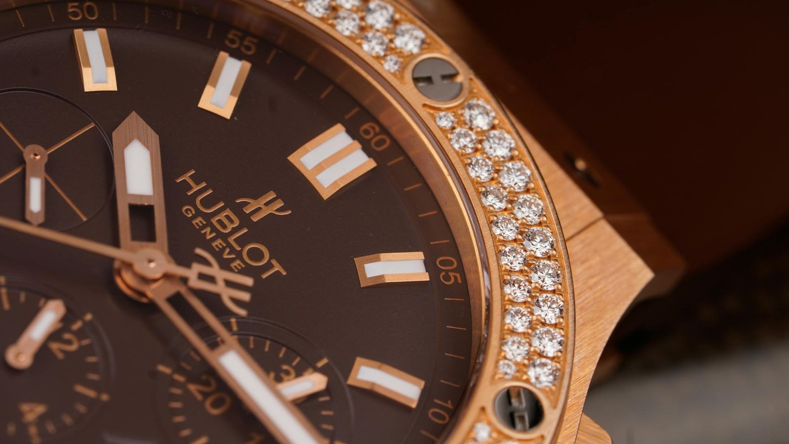 Close-up of an elegant luxury watch featuring a diamond-studded bezel and sleek design.