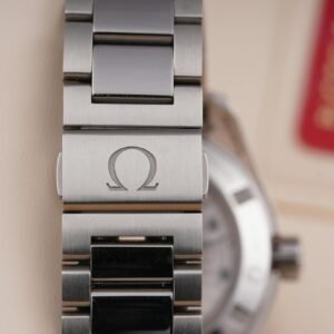 Detailed close-up of a luxury silver watch bracelet with Omega branding.